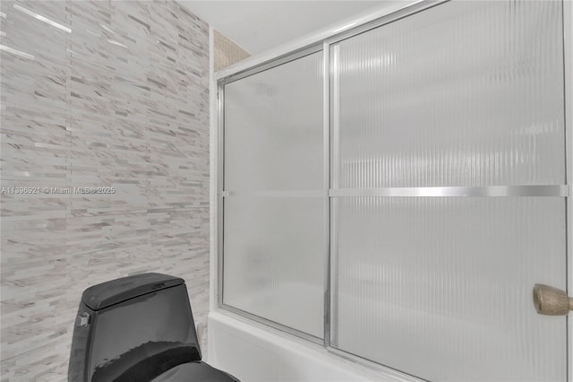 full bathroom featuring enclosed tub / shower combo and tile walls