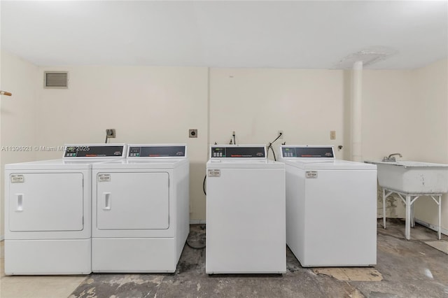 common laundry area featuring washer and clothes dryer and visible vents