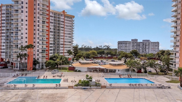 community pool with fence and a patio