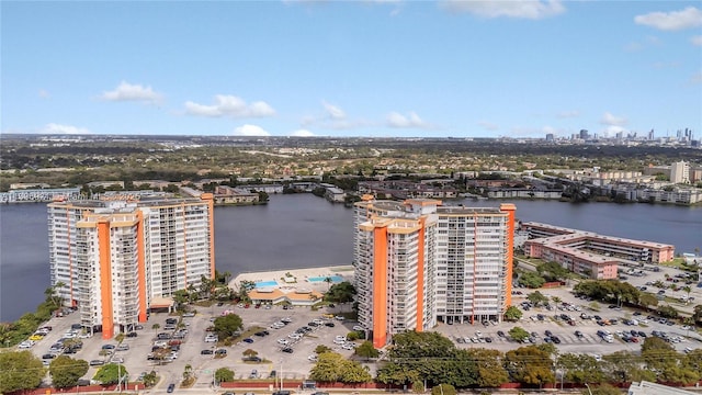 drone / aerial view featuring a city view and a water view