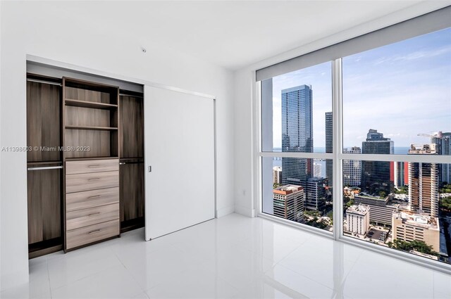 tiled bedroom with a closet