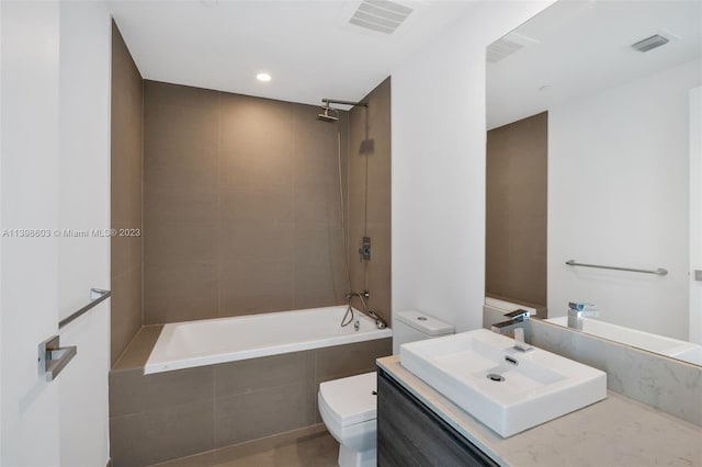 full bathroom featuring toilet, tiled shower / bath combo, and oversized vanity