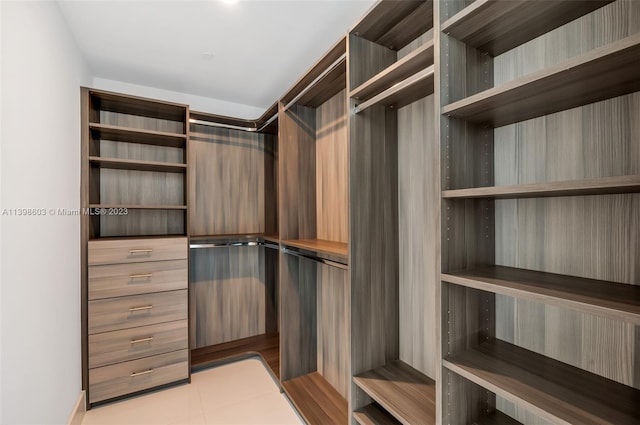 spacious closet featuring light tile floors