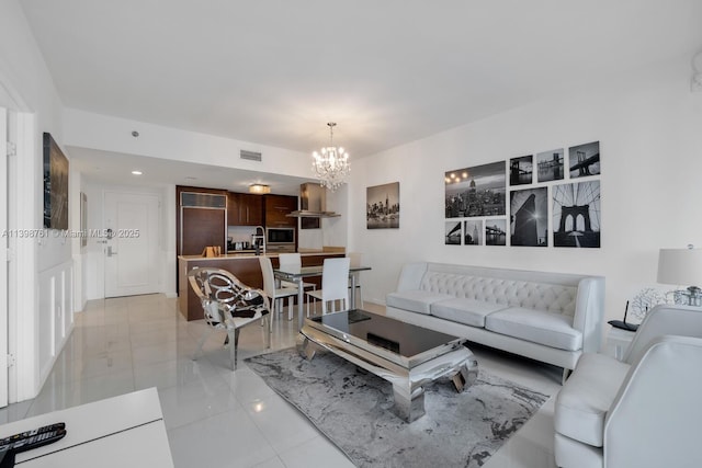 living room with light tile patterned floors and a chandelier