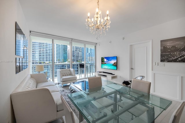 dining space with expansive windows and a notable chandelier