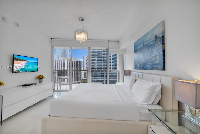 bedroom featuring light tile patterned floors, access to exterior, and a chandelier