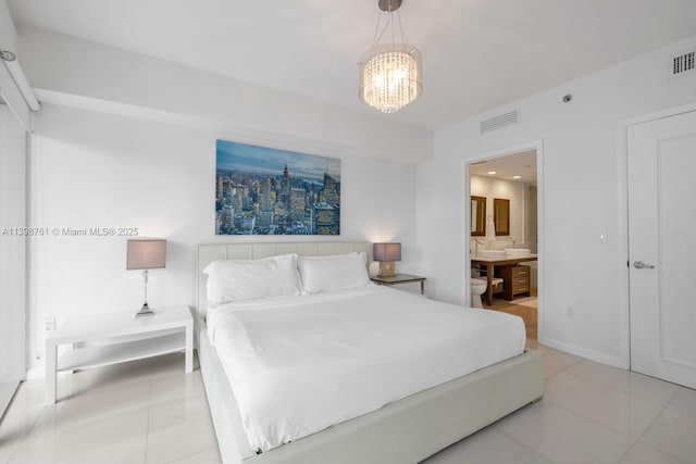 bedroom featuring light tile patterned flooring, connected bathroom, and a notable chandelier