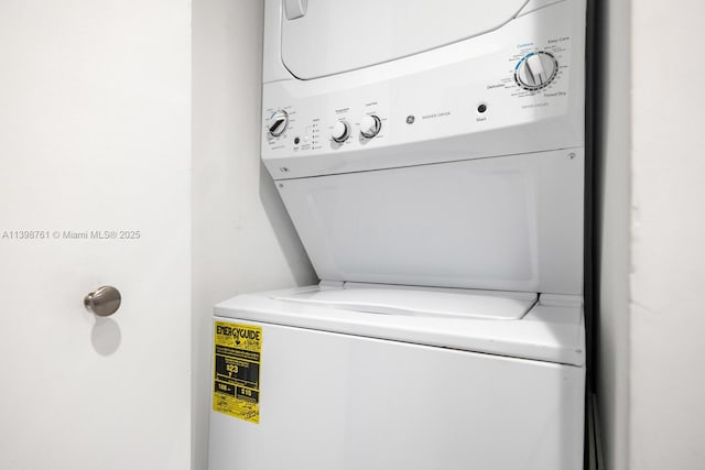 clothes washing area featuring stacked washer / drying machine