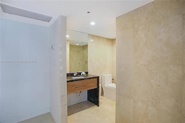 bathroom featuring sink, a shower with door, tile patterned flooring, and toilet