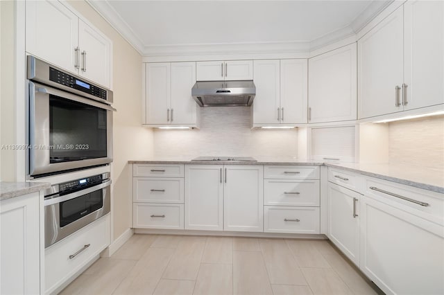 kitchen with black electric cooktop, white cabinetry, and light stone counters