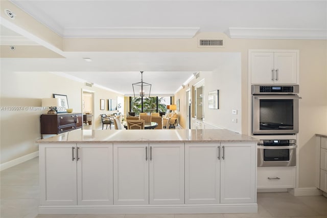 kitchen featuring light tile flooring, double oven, white cabinetry, and light stone counters