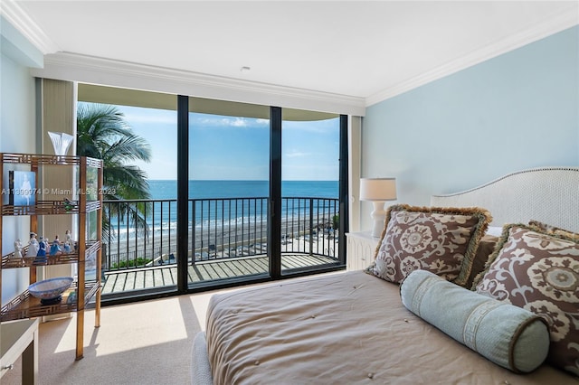 bedroom featuring crown molding, access to exterior, a water view, and a wall of windows