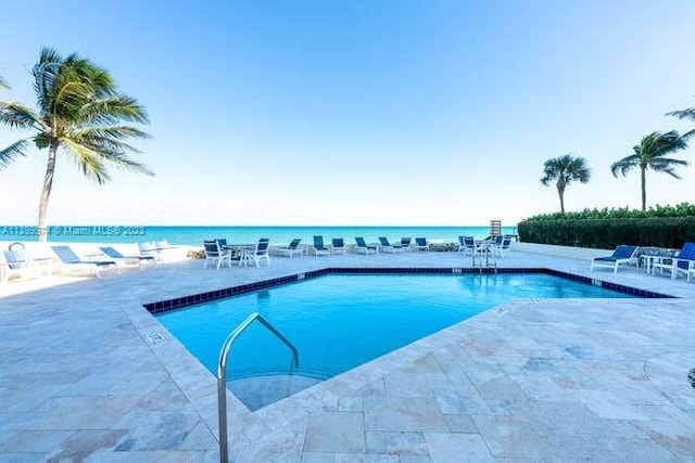 view of pool with a water view