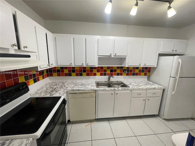 kitchen with backsplash, light tile flooring, white appliances, sink, and white cabinets