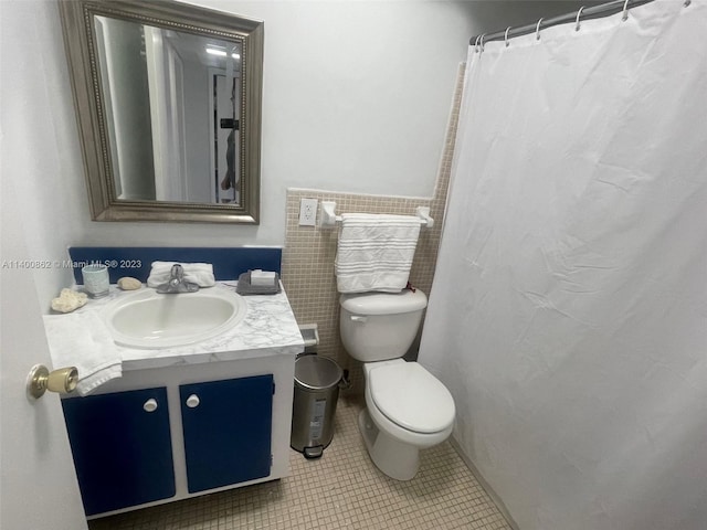 bathroom featuring tile floors, toilet, and vanity