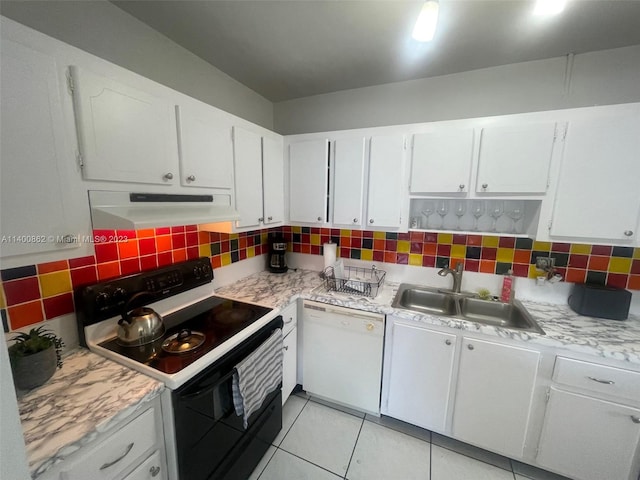 kitchen featuring white appliances, sink, light tile floors, white cabinets, and tasteful backsplash