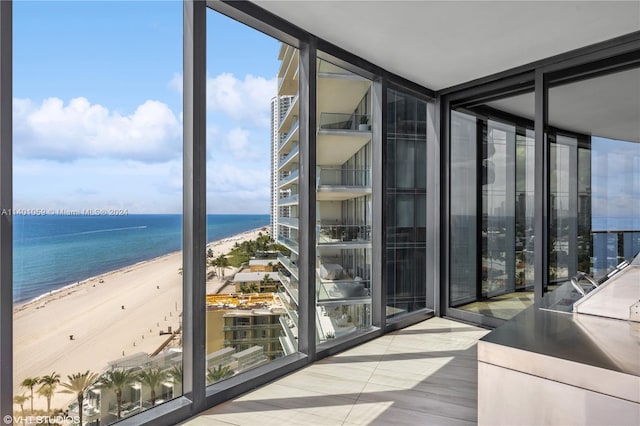 interior space featuring a water view and a view of the beach