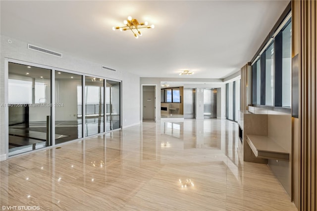 interior space with a chandelier, light tile flooring, and a wealth of natural light