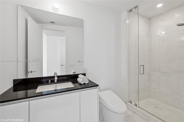 bathroom with toilet, large vanity, tile floors, and an enclosed shower