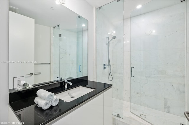 bathroom featuring walk in shower and vanity