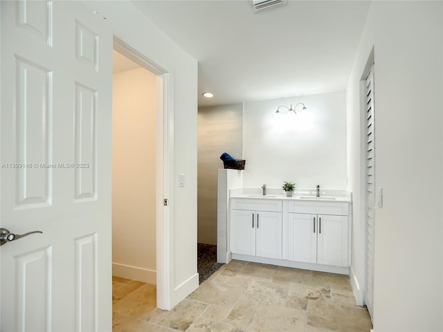 bathroom with vanity and tile flooring