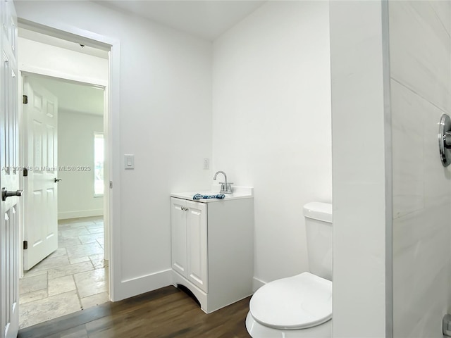 bathroom featuring toilet, tile floors, and vanity