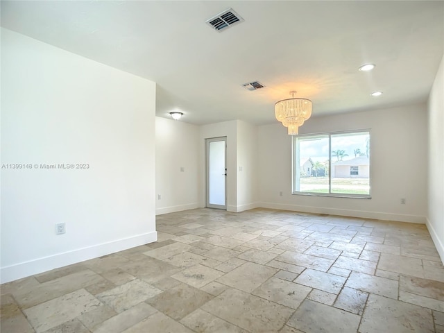 tiled empty room with a notable chandelier