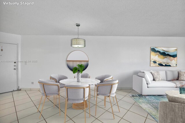 living room with light tile floors and a textured ceiling