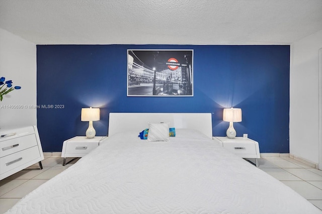 bedroom with a textured ceiling and light tile flooring