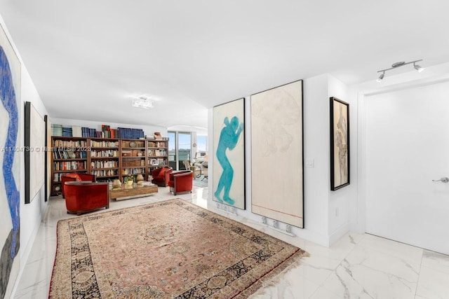 living area featuring light tile floors and track lighting