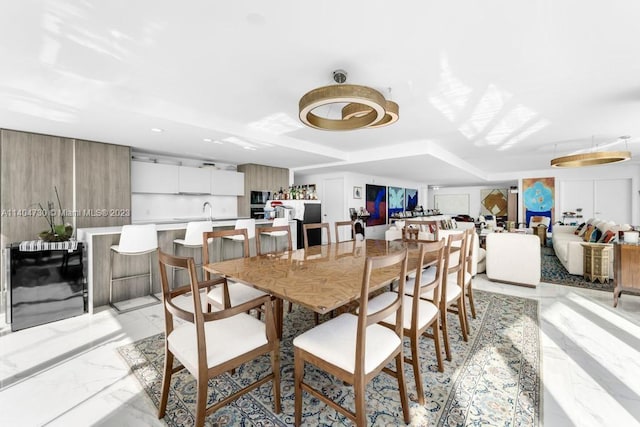 dining space featuring light tile floors and sink