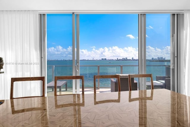 interior space featuring expansive windows and a water view