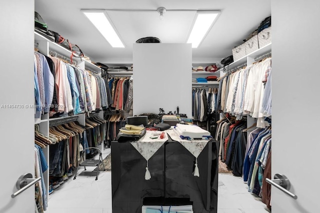 spacious closet with light tile floors