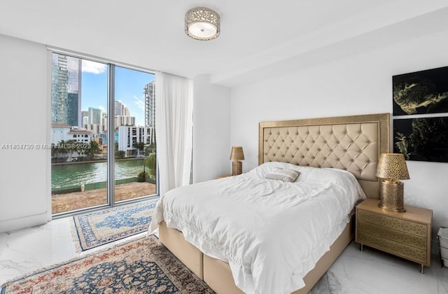 bedroom with light tile floors, a wall of windows, multiple windows, and a water view