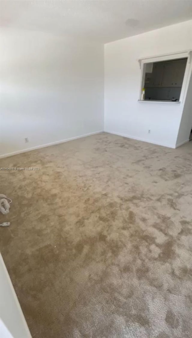 spare room featuring carpet floors