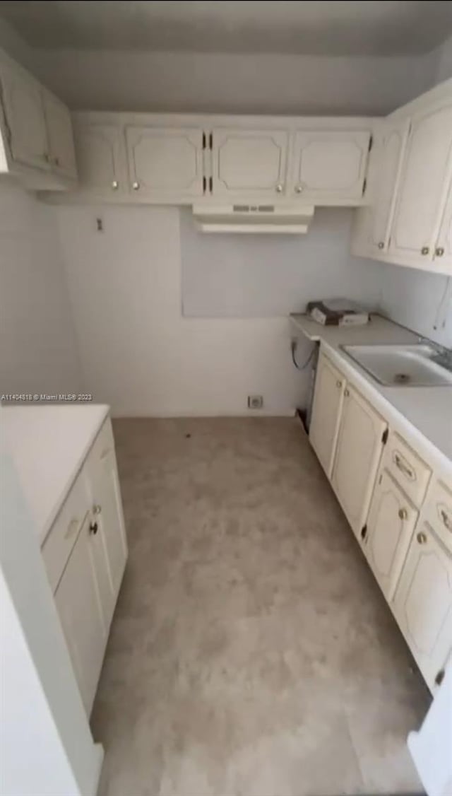 kitchen featuring white cabinets and sink