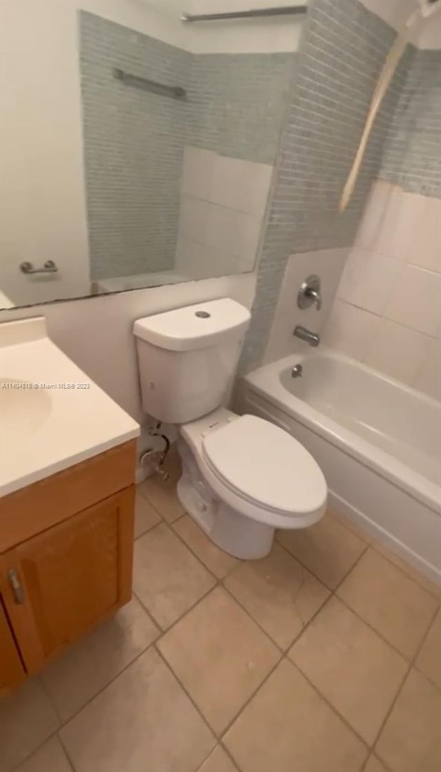 full bathroom featuring bathing tub / shower combination, toilet, tile floors, and vanity