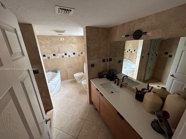 bathroom featuring toilet, a textured ceiling, vanity with extensive cabinet space, tile walls, and tile flooring