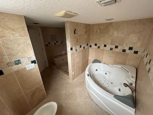 bathroom featuring tile walls, tile floors, toilet, and a textured ceiling