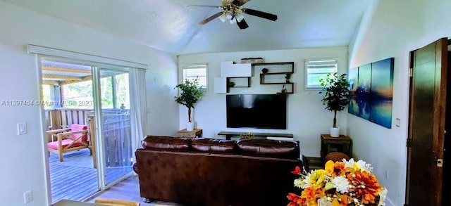 living room with light hardwood / wood-style flooring, ceiling fan, and a wealth of natural light