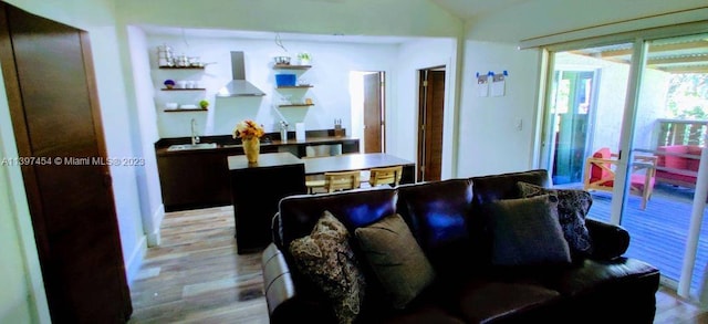 living room featuring light wood-type flooring and sink