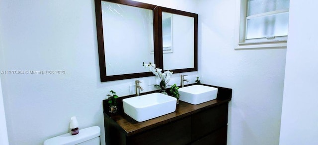 bathroom with large vanity and toilet