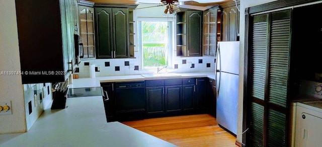 kitchen featuring black appliances, ceiling fan, sink, light wood-type flooring, and tasteful backsplash