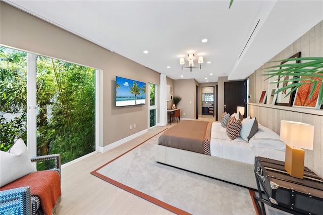 bedroom featuring a notable chandelier and light wood-type flooring