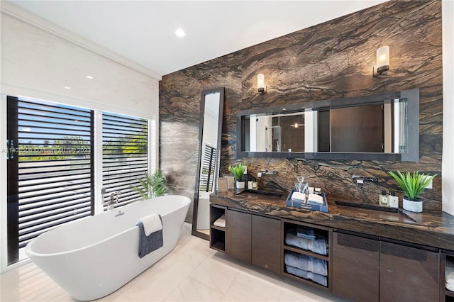 bathroom featuring tile floors, a bath, and vanity