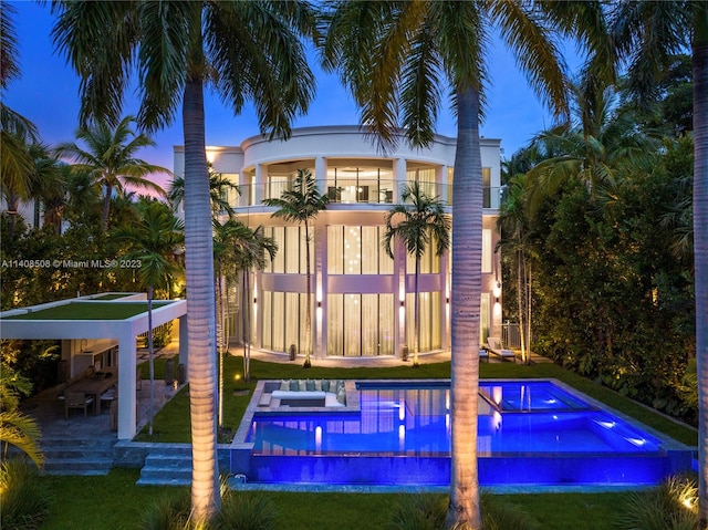 exterior space with a balcony, a patio area, and a yard