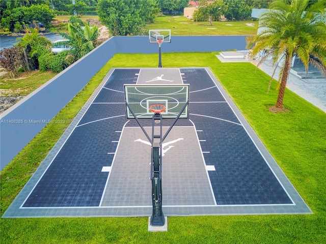 view of basketball court featuring a yard