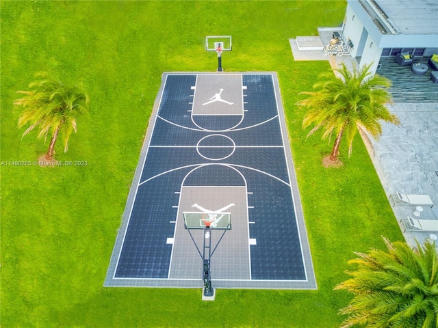 view of basketball court with a lawn