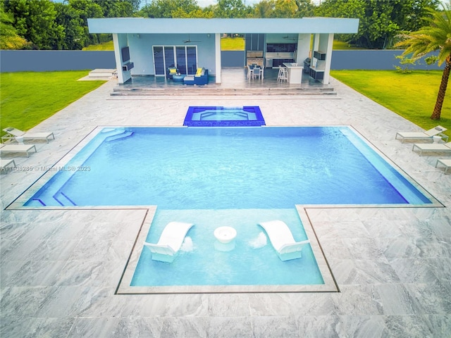 view of swimming pool with a patio area, an in ground hot tub, and a lawn