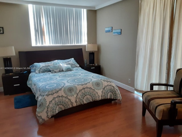 bedroom featuring crown molding and hardwood / wood-style floors